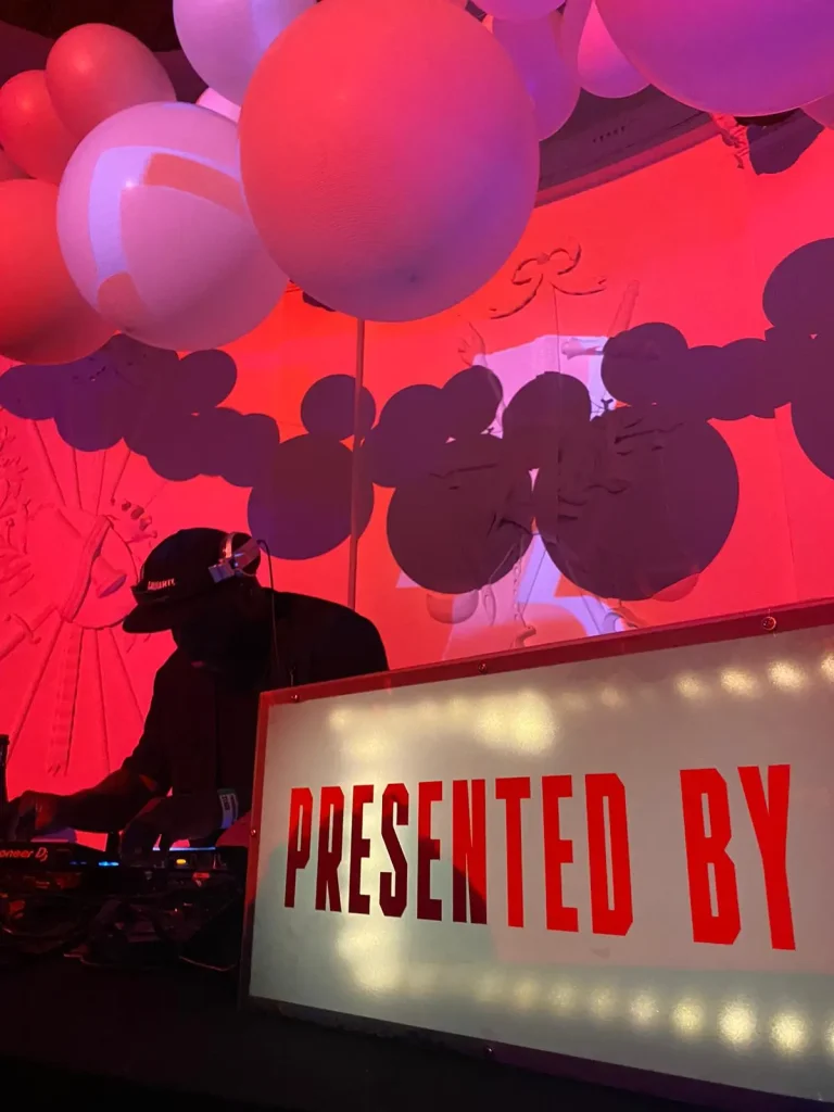 DJ "YDNAS" playing; with a lightbox with the Presented By logo
